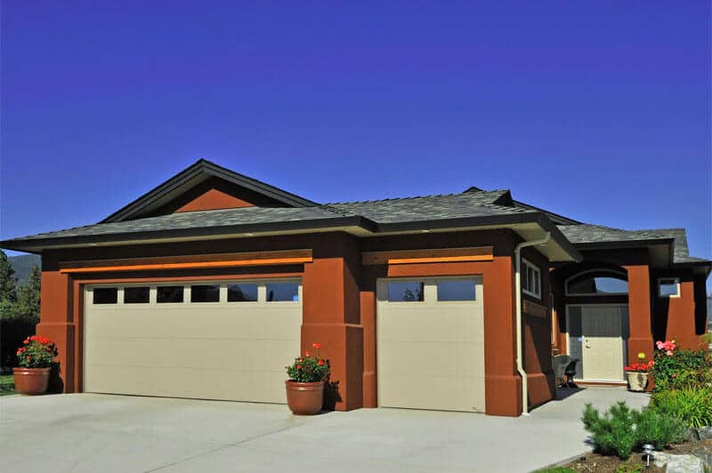 Flush residential garage door by Legacy Garage Doors in Kelowna, featuring a smooth, minimalist design with clean, flat panels.