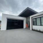 Esteem garage door with dark tint and privacy glass by Legacy Garage Doors