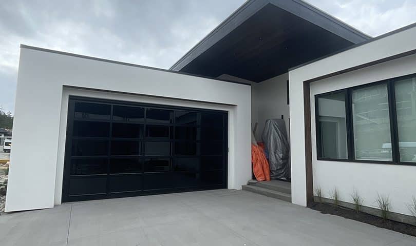 Esteem garage door with dark tint and privacy glass by Legacy Garage Doors