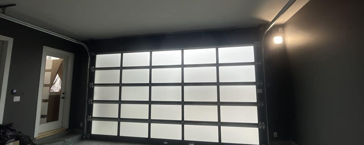 Esteem garage door with dark tint and privacy glass, inside and outside view by Legacy Garage Doors