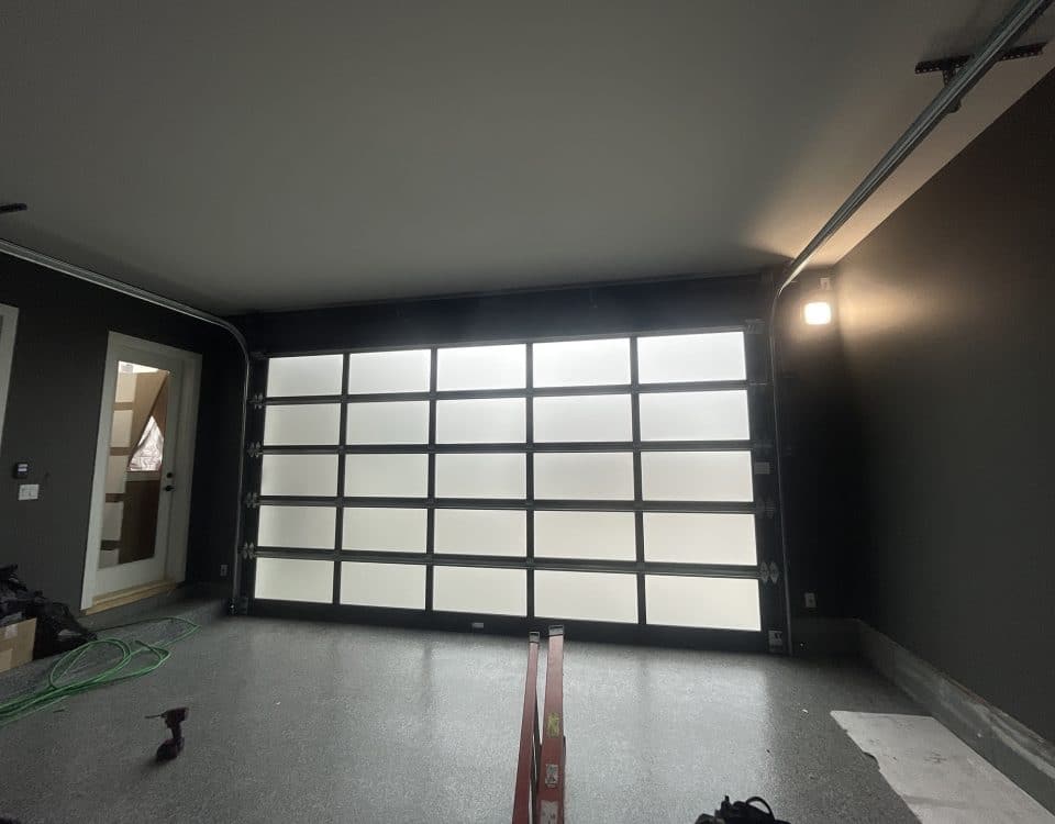 Esteem garage door with dark tint and privacy glass, inside and outside view by Legacy Garage Doors