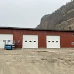 16x14-foot steel garage door featuring evenly spaced glass panels for a modern commercial building design