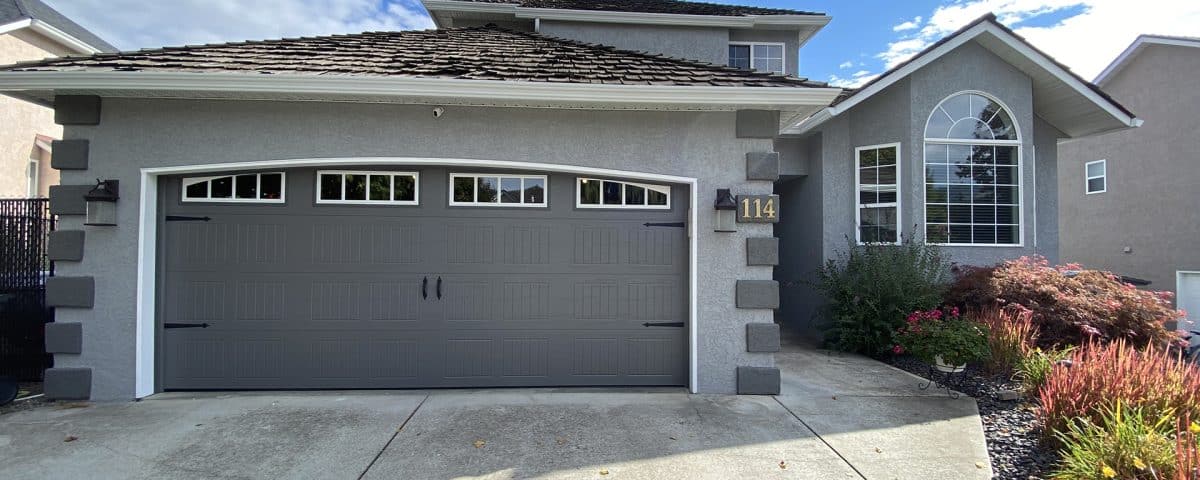 16x7-foot carriage-style garage door in sable grey, featuring a classic design with paneling for residential use