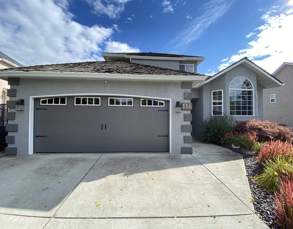 16x7-foot carriage-style garage door in sable grey, featuring a classic design with paneling for residential use