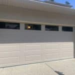 RC16 sandstone garage door with top panel glass by Legacy Garage Doors