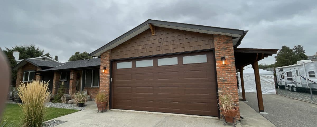 Ranch Craft walnut garage door with top panel glass by Legacy Garage Doors