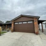 Ranch Craft walnut garage door with top panel glass by Legacy Garage Doors
