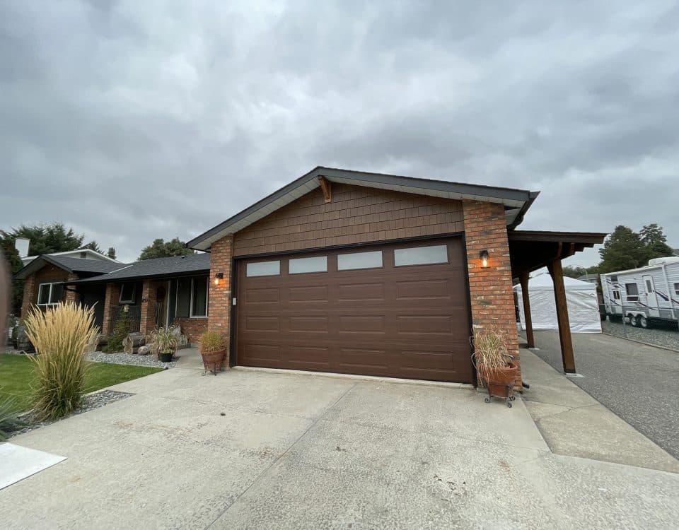 Ranch Craft walnut garage door with top panel glass by Legacy Garage Doors