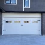 Carriage Craft garage door with decorative hardware and glass panels by Legacy Garage Doors
