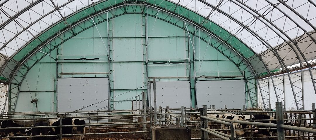 Commercial metal garage door for a Quonset building, featuring a durable steel design for industrial use.