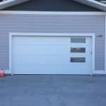 Flush white garage door with double-pane satin glass panels by Legacy Garage Doors