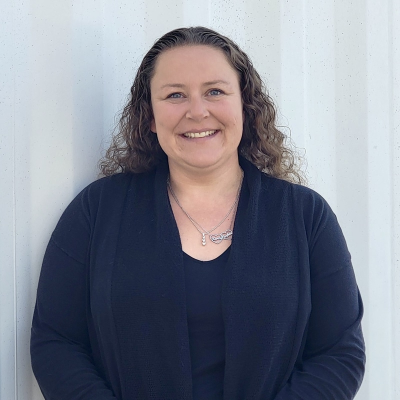 Headshot of Amanda with an approachable demeanor, wearing business attire and smiling warmly