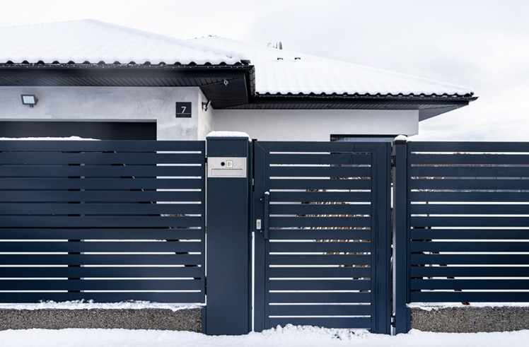 Black gate featuring a sleek and modern design, providing a stylish entrance to a property