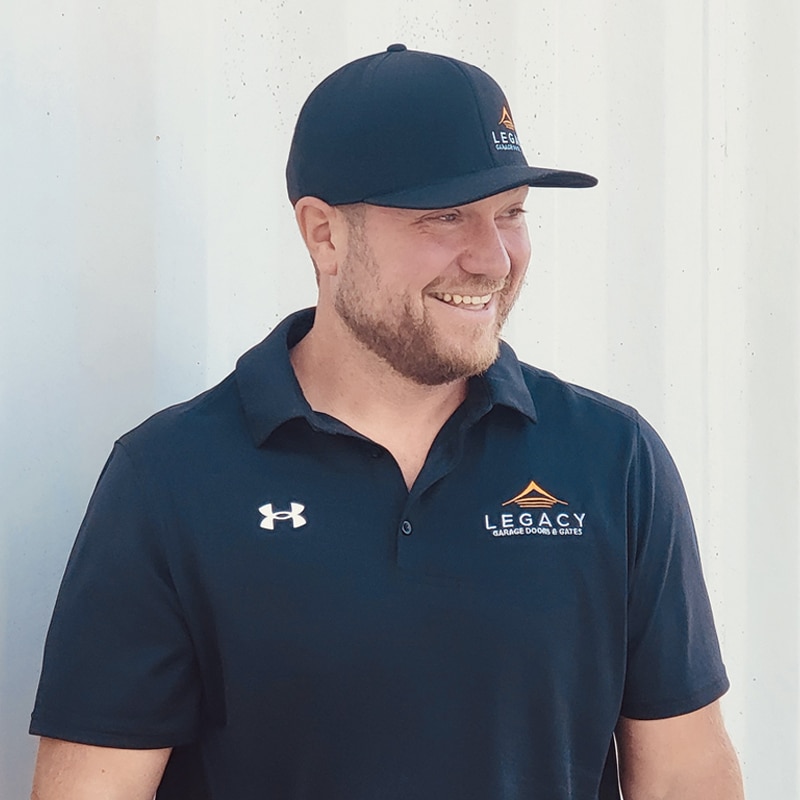 Headshot of Kurtis with a professional appearance, wearing a company shirt and smiling