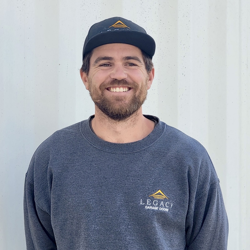 Headshot of Mike with a confident expression, dressed in company shirt and smiling