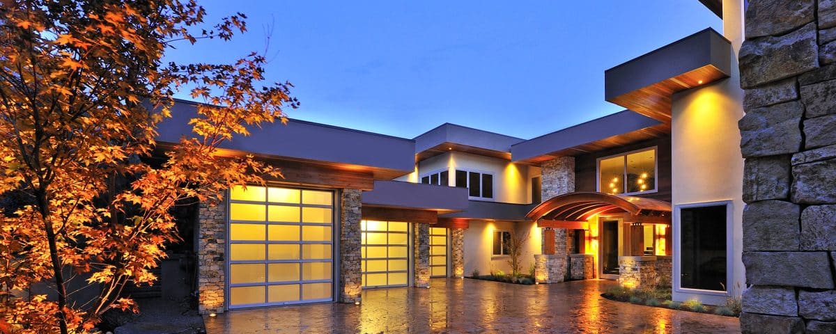 Garage door installed by Legacy Garage Doors, illuminated at night