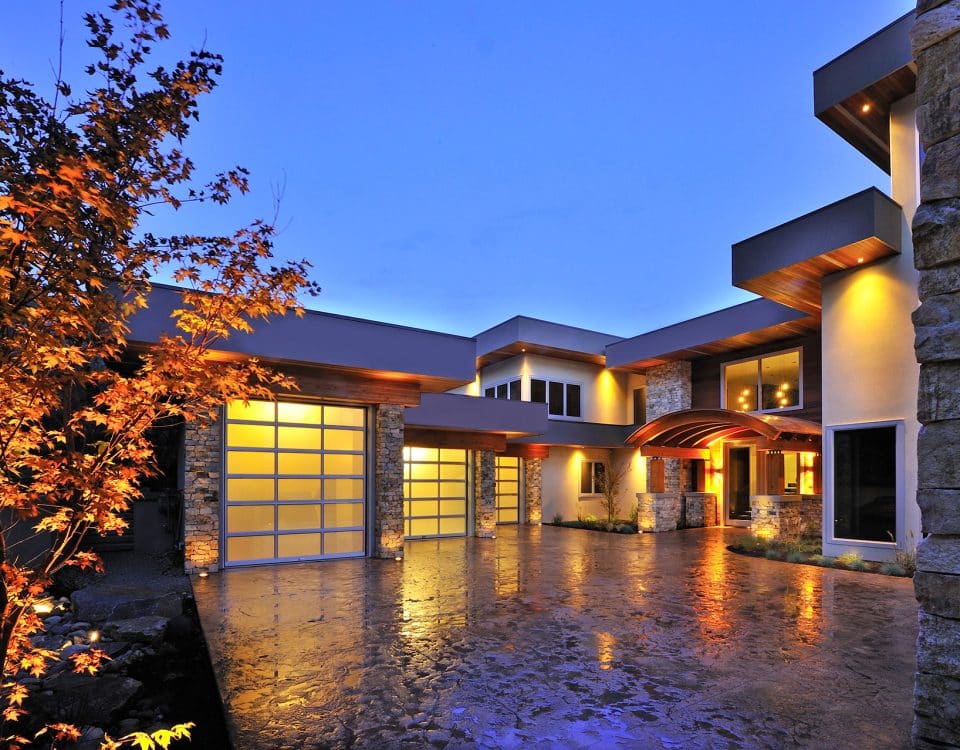 Garage door installed by Legacy Garage Doors, illuminated at night