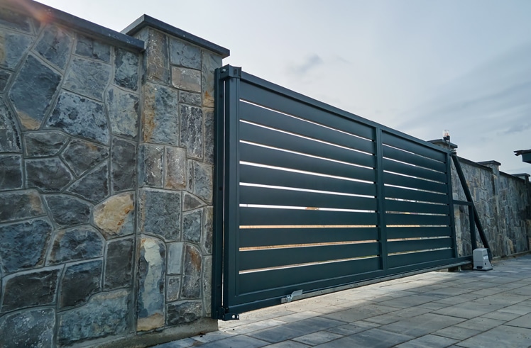 Wide automatic sliding gate featuring a contemporary design with sleek lines and a modern finish